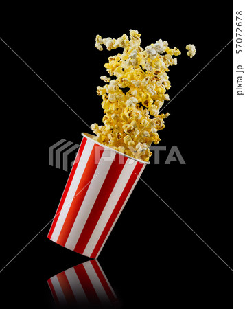 Paper striped bucket with popcorn isolated on black background 57072678