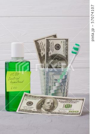 Oral hygiene tools, money and dentist appointment reminder. 57074107