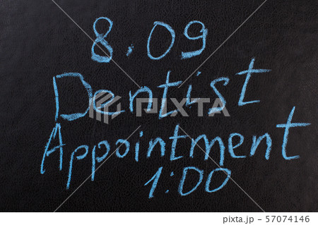 Dentist appointment reminder on chalkboard. Dentist appointment reminder on chalkboard. 57074146