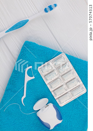 Toothbrush, dental floss, chewing gums and towel. Toothbrush, dental floss, chewing gums and towel. 57074313