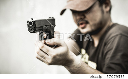 Man and gun. 57079535