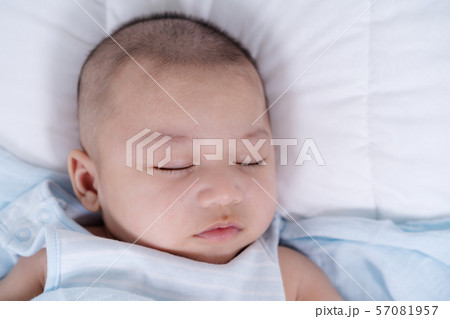 baby sleeping on a bed at home 57081957
