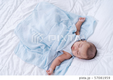 baby sleeping on a bed at home baby sleeping on a bed at home 57081959