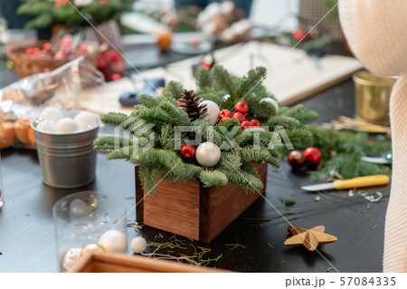 Christmas decor with their own hands. Woman created a xmas arrangement. Master class on making Christmas decor with their own hands. Woman created a xmas arrangement. Master class on making 57084335