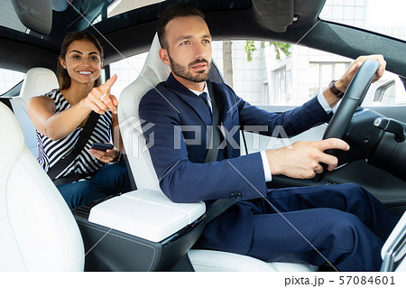 Smiling wife showing the route while husband driving 57084601