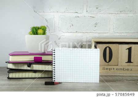 September still life with books and potted plant 57085649