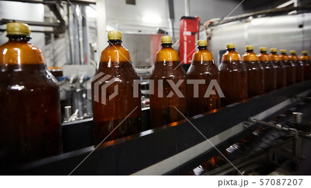The new plastic bottles on the conveyor belt at the drinking beer factory. Drinking water 57087207