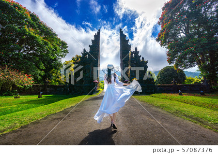 Woman walking at big entrance gate Woman walking at big entrance gate 57087376