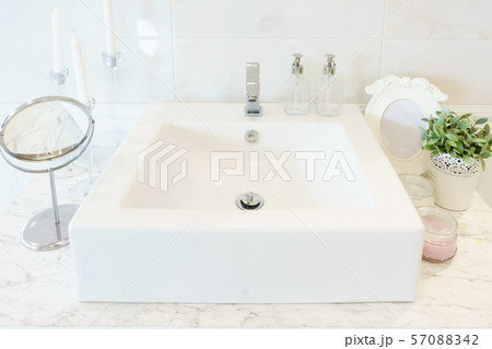 Interior of bathroom with sink basin faucet and mirror Interior of bathroom with sink basin faucet and mirror 57088342