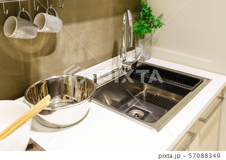 modern white kitchen with stainless steel appliances  57088349