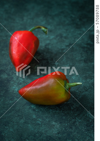 Red peppers lie on gray concrete 57089788