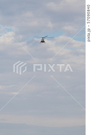 A helicopter flying in the cloudy sky 57090840