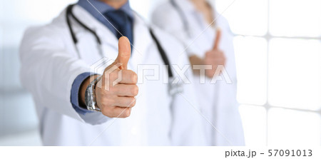 Group of doctors showing thumbs up. Perfect medical service in clinic. Happy future in medicine and 57091013