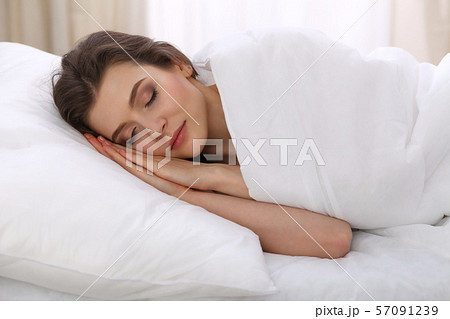 Beautiful young woman sleeping while lying in her bed. Concept of pleasant and rest reinstatement 57091239