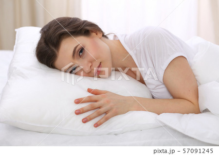 Beautiful young woman sleeping while lying in her bed. Concept of pleasant and rest reinstatement 57091245