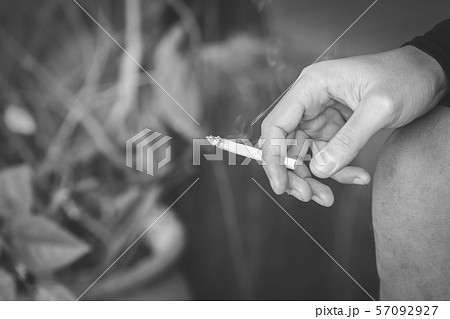 Close up male in hand holding a cigarette. Close up male in hand holding a cigarette. 57092927
