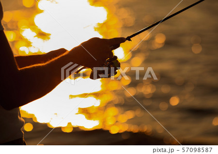 Young man fishing at sea 57098587