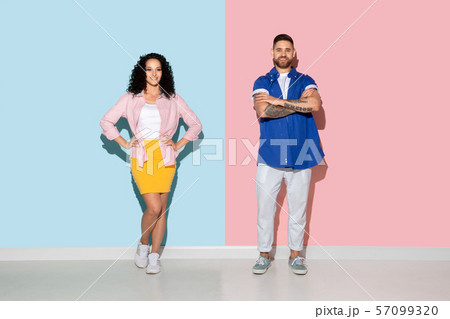 Young emotional man and woman on pink and blue background 57099320