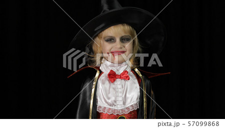 Dracula child. Girl with halloween make-up. Vampire kid with blood on her face 57099868