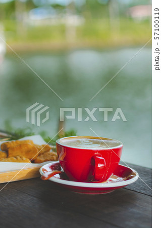 A cup of Latte on wooden table. A cup of Latte on wooden table. 57100119
