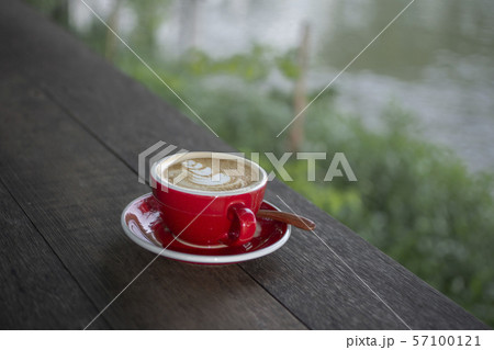 A cup of Latte on wooden table. A cup of Latte on wooden table. 57100121
