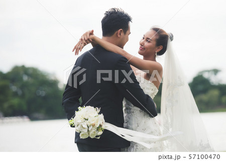 asia bride and groom on the background of river 57100470
