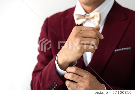 Young man wearing red suit with bow tie 57100810
