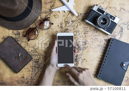 Retro camera with toy plane and smartphone on old 57100811