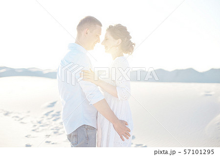 Loving couple kissing at sunset. love in the sun. Valentine's day in nature beach. Loving couple kissing at sunset. love in the sun. Valentine's day in nature beach. 57101295
