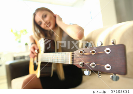 Female Bass Guitarist Performing Music at Home 57102351