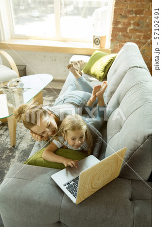 Teacher and little girl, or mom and daughter. Homeschooling concept Teacher and little girl, or mom and daughter. Homeschooling concept 57102491