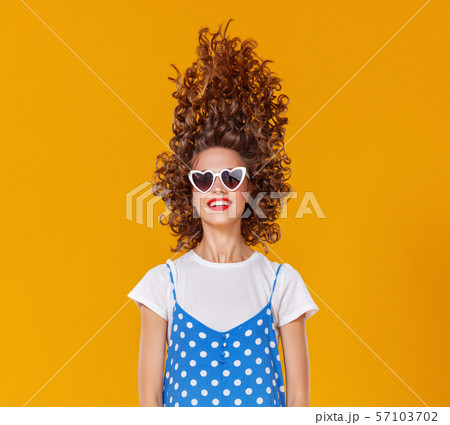 beautiful funny girl on colored yellow background. 57103702