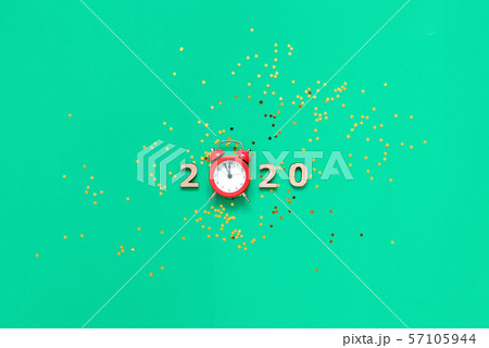 2020 text and red alarm clock with countdown to new year. green background ang golden glitter stars 2020 text and red alarm clock with countdown to new year. green background ang golden glitter stars 57105944