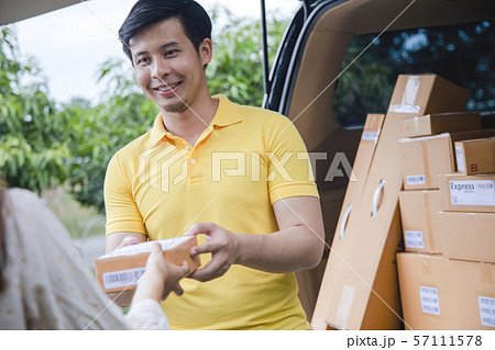 Young Asian Delivery man delivering packages Young Asian Delivery man delivering packages 57111578