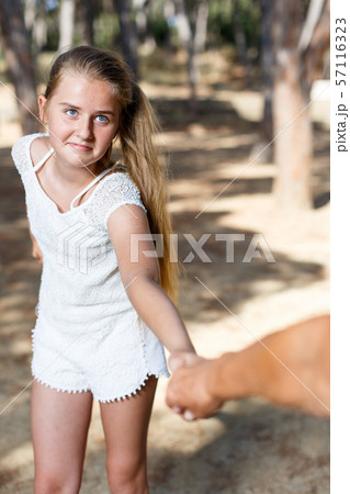 Teenage girl hold grandmother on hand in green park at summer day 57116323