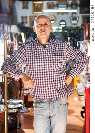 Mature man posing in antiques shop Mature man posing in antiques shop 57116467