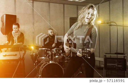 excited girl rock singer with guitar during rehearsal excited girl rock singer with guitar during rehearsal 57116591