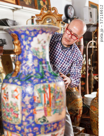 Man choosing ancient things in store Man choosing ancient things in store 57116612