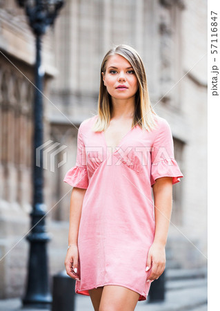 Young serious female standing in the historical city center of Barcelona 57116847
