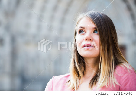 Close up of young woman standing at the street among architecture Close up of young woman standing at the street among architecture 57117040