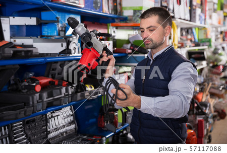 Man choosing drilling machine Man choosing drilling machine 57117088