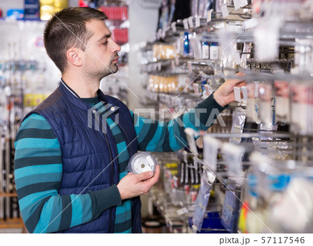 shopper choosing fishing accessories shopper choosing fishing accessories 57117546