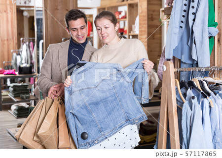 Young female with male are looking on jeans blouse for her Young female with male are looking on jeans blouse for her 57117865
