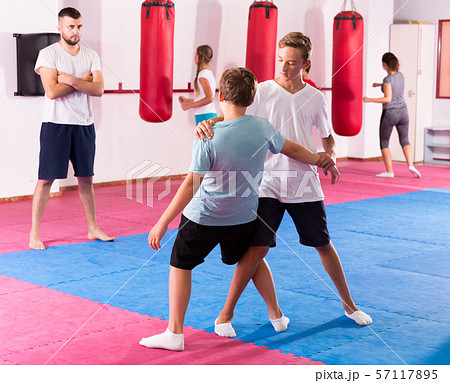 Kids practicing in pair self-protection Kids practicing in pair self-protection 57117895