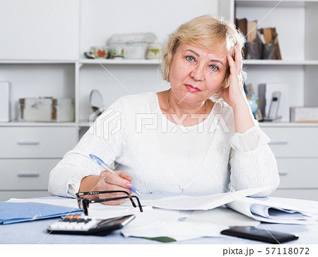 Woman engaged in home accounting Woman engaged in home accounting 57118072