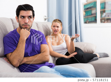 Frustrated guy on couch with dissatisfied girlfriend 57118151