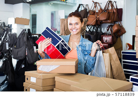 friendly teenager girl holding boxes in shoes boutique friendly teenager girl holding boxes in shoes boutique 57118839