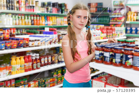 Tweenage girl buying food in supermarket 57120395