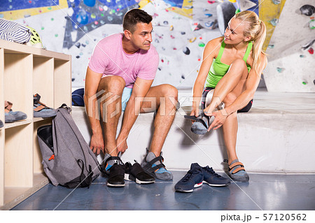 Sports people dressing for mountaineering outfit Sports people dressing for mountaineering outfit 57120562