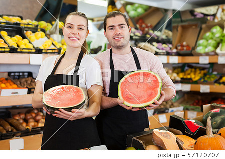 Young woman and man holding half of watermelon 57120707
